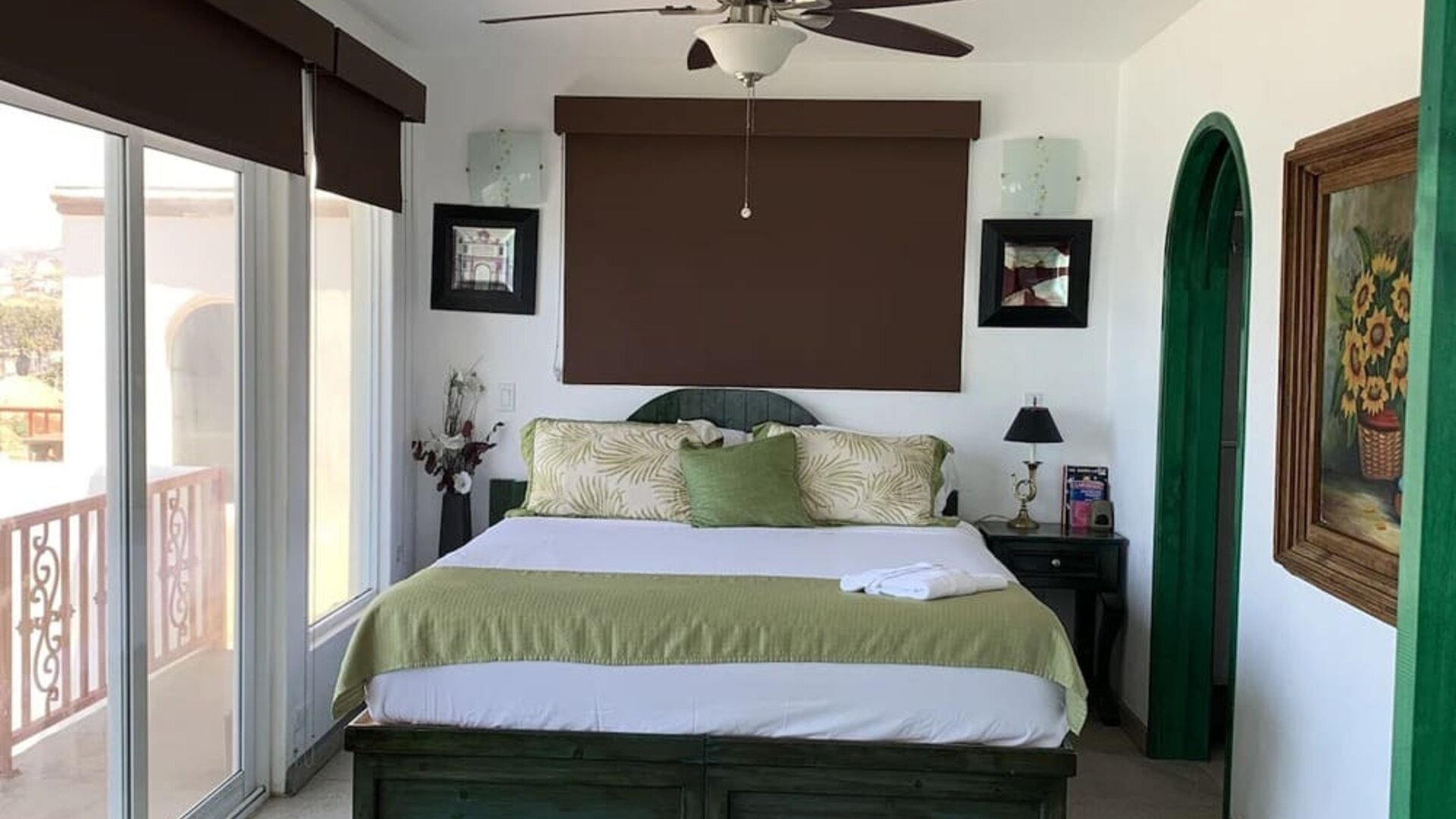 Spacious bedroom with king-size bed, private balcony, and contemporary coastal décor at Casa Playa Baja Resort.