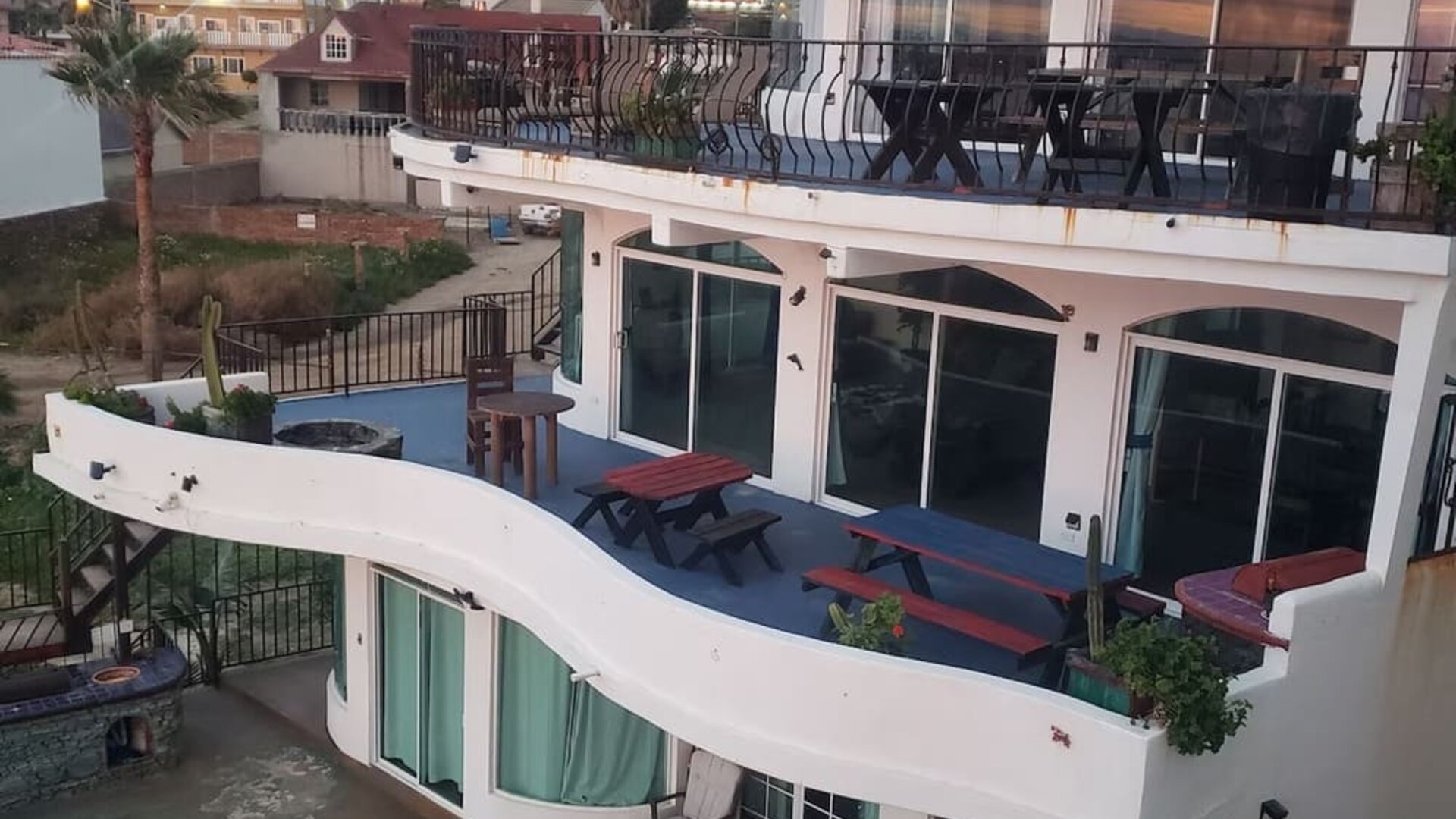 Exterior view of the multi-level beachfront resort featuring private balconies and outdoor terraces at Casa Playa Baja Resort.