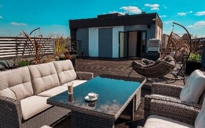 Rooftop terrace with comfortable outdoor seating and city views at Hotel Seven.