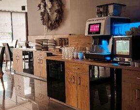 Self-service coffee station with Costa Coffee machine in the breakfast area at Hotel Seven.