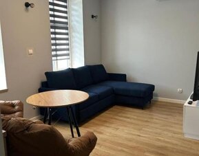 Comfortable apartment lounge with sofa, TV and air conditioning at Hotel Seven.