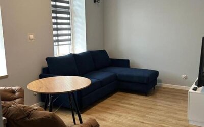 Comfortable apartment lounge with sofa, TV and air conditioning at Hotel Seven.