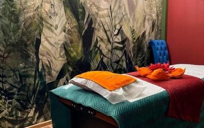 Spa treatment room with massage table, botanical mural and relaxing atmosphere at Hotel Seven.