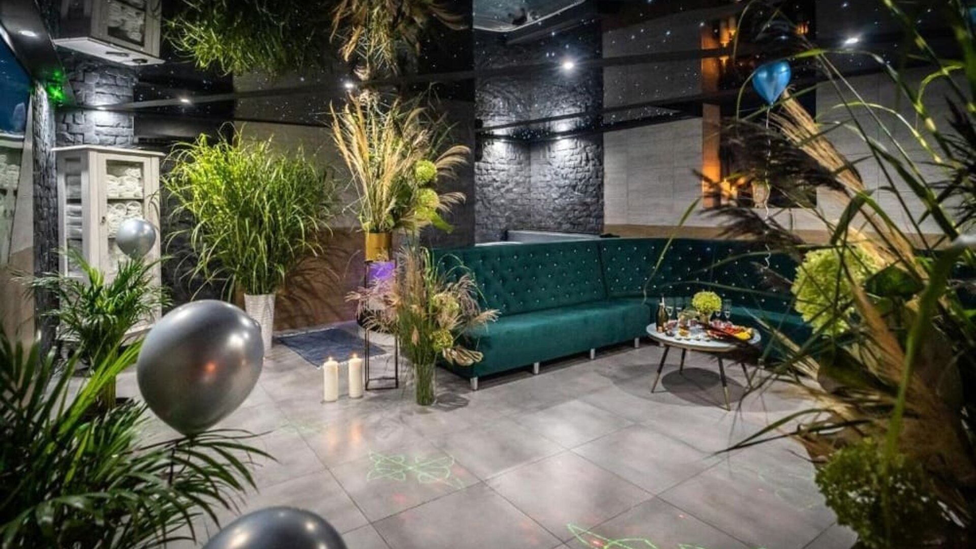 Stylish spa lounge with modern seating, greenery and ambient lighting at Hotel Seven.