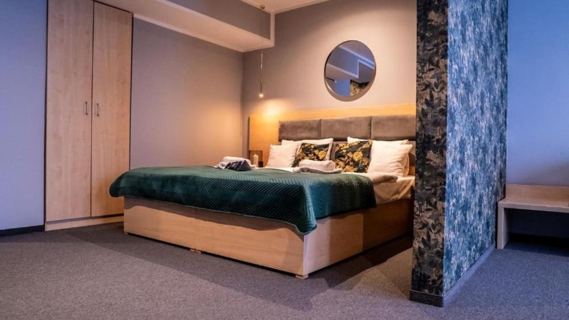 Spacious Hotel Seven bedroom with king-size bed, modern wardrobe and elegant décor.