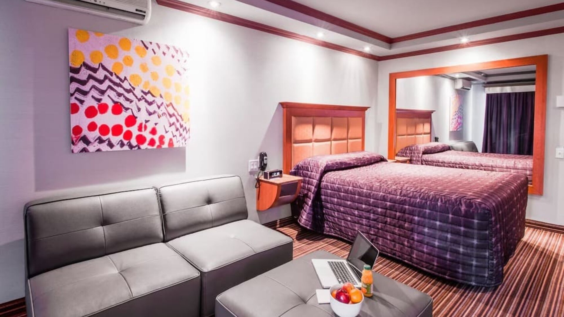 Comfortable guest room with king-size bed, seating area and modern furnishings at Le Chabrol Hotel Et Suites.