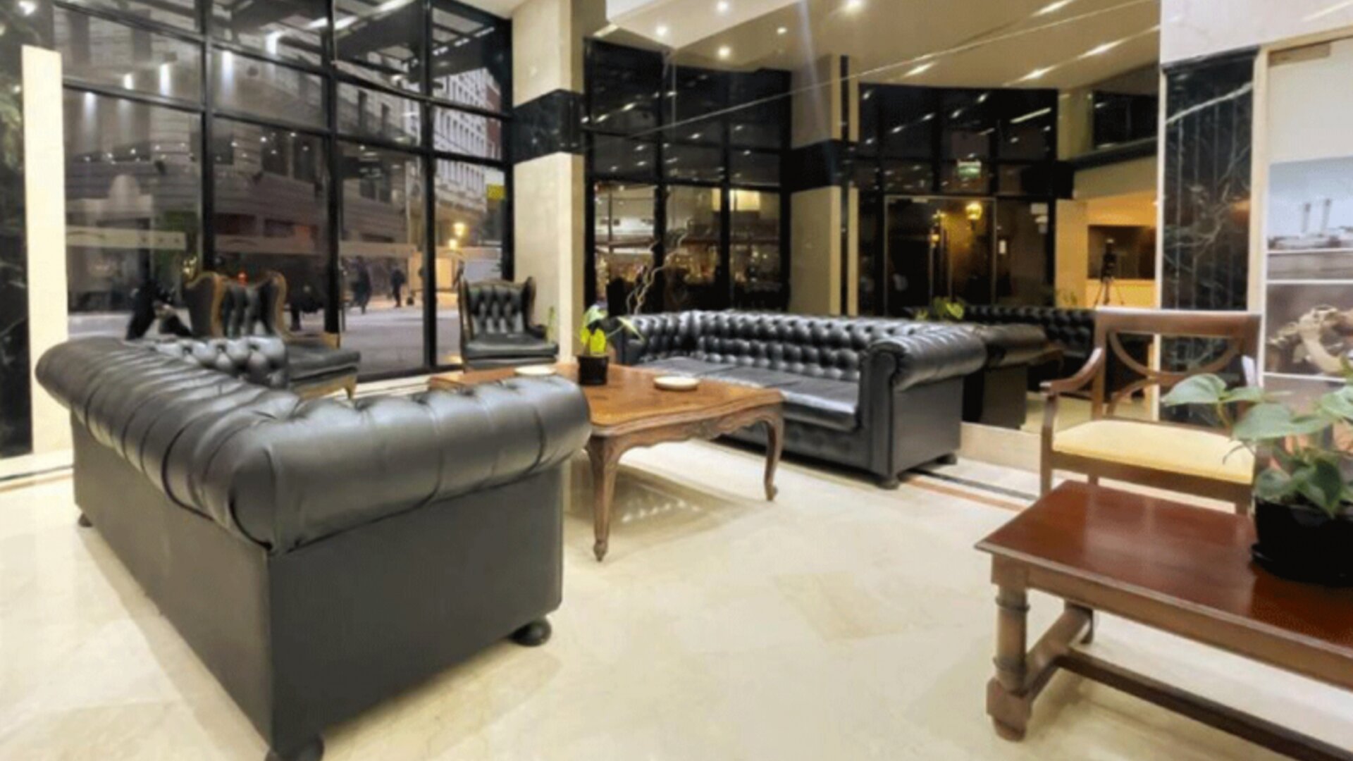 Lounge section within the lobby featuring classic leather sofas, large floor-to-ceiling windows, and a relaxing space for socializing or unwinding at HR Plaza Luxor.