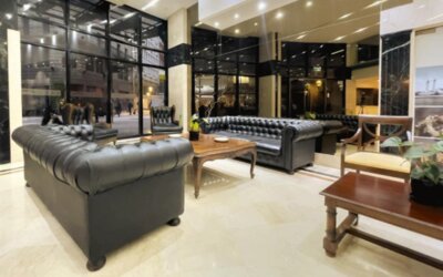 Lounge section within the lobby featuring classic leather sofas, large floor-to-ceiling windows, and a relaxing space for socializing or unwinding at HR Plaza Luxor.