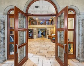 Grand entrance leading into the welcoming hotel lobby at Hotel Brossard.