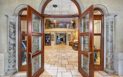 Grand entrance leading into the welcoming hotel lobby at Hotel Brossard.