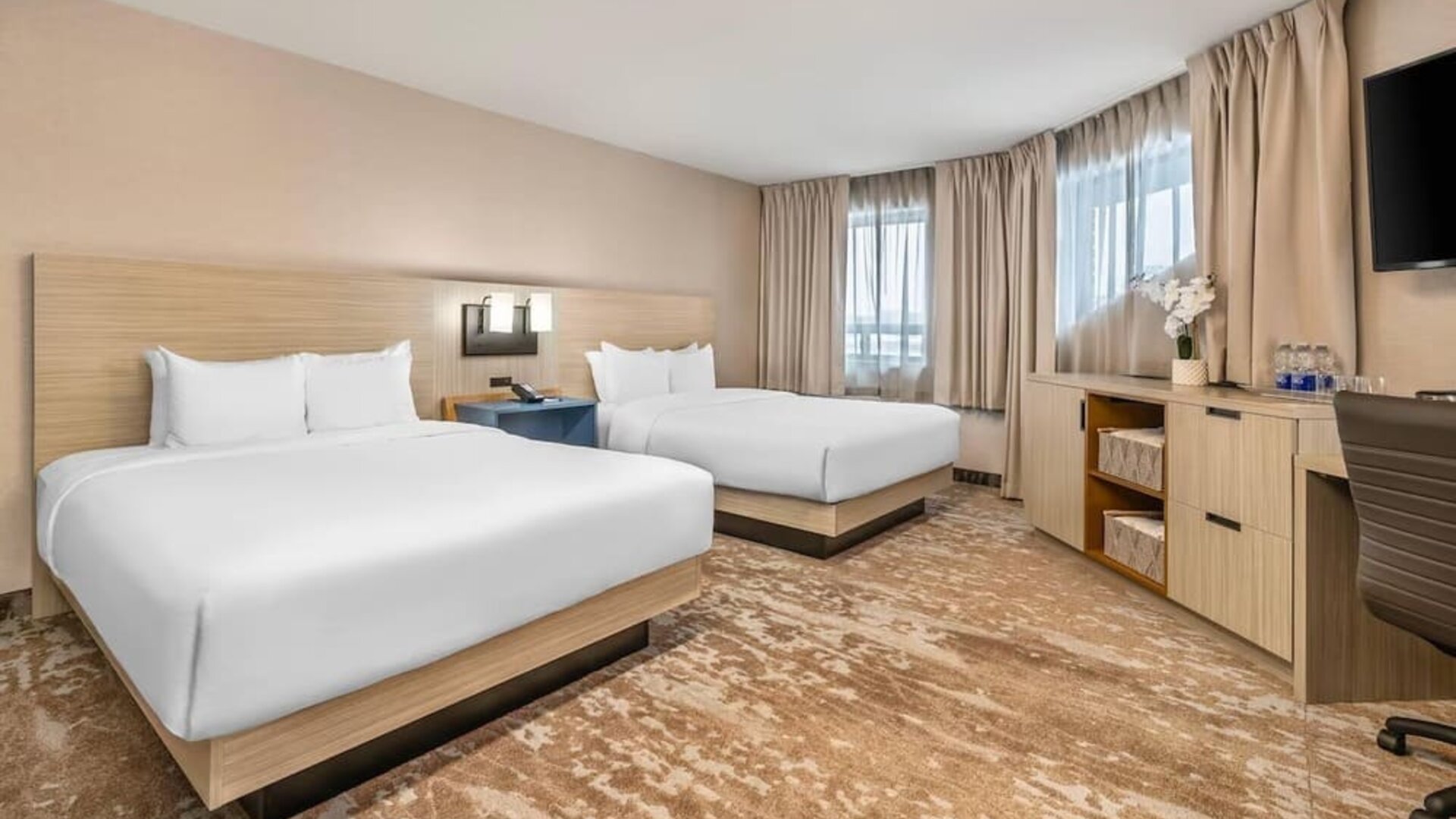 Spacious guest room with two queen beds and contemporary furnishings at Comfort Inn Laval.