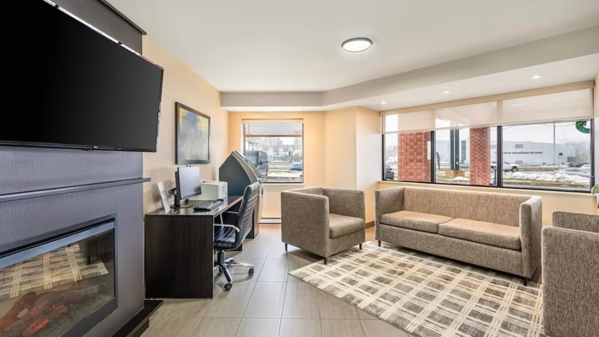 Inviting lobby lounge with fireplace, business centre and comfortable seating at Comfort Inn Laval.