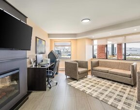 Inviting lobby lounge with fireplace, business centre and comfortable seating at Comfort Inn Laval.