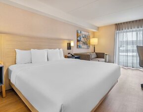Bright king guest room with contemporary furnishings and spacious layout at Comfort Inn Laval.