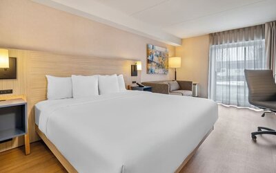 Bright king guest room with contemporary furnishings and spacious layout at Comfort Inn Laval.