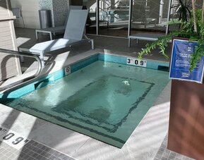 Indoor hot tub with lounge seating for relaxation at Hilton Garden Inn Calgary Downtown.