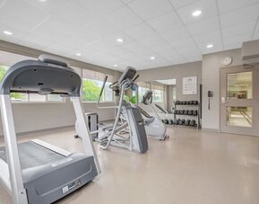 Fitness center featuring cardio equipment, free weights and exercise space at Days Inn & Suites By Wyndham Lindsay.