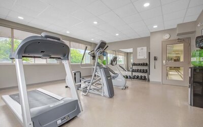 Fitness center featuring cardio equipment, free weights and exercise space at Days Inn & Suites By Wyndham Lindsay.