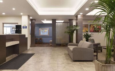 Bright hotel lobby with reception area, comfortable seating and contemporary décor at Days Inn & Suites By Wyndham Lindsay.