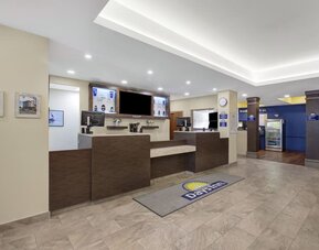Modern reception area with front desk and welcoming lobby at Days Inn & Suites By Wyndham Lindsay.