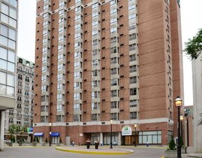 Exterior façade of Holiday Inn Express Toronto Downtown surrounded by the city's business and entertainment district.