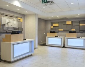 Modern reception area with front desk and welcoming check-in space at Holiday Inn Express Toronto Downtown.