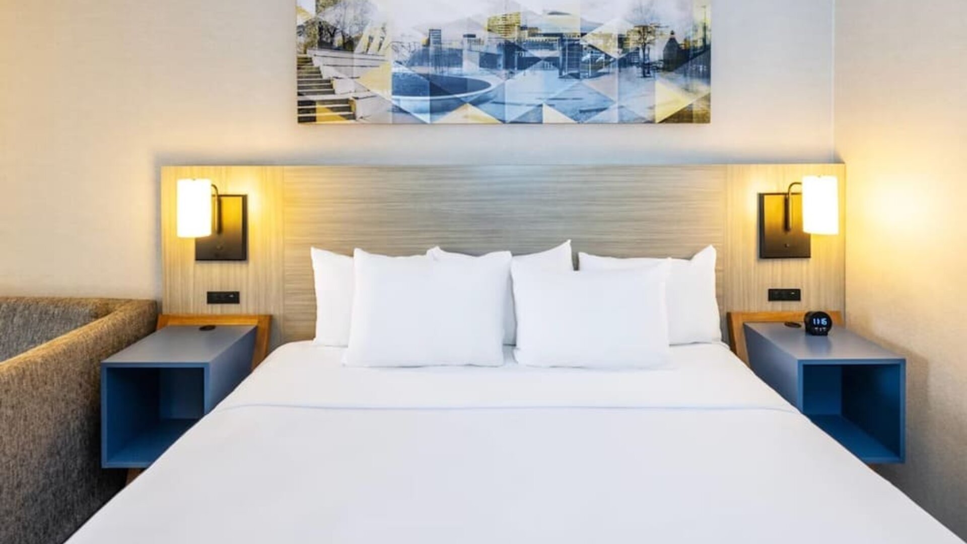 Inviting king bed with premium linens and modern bedside lighting for a restful stay at Comfort Inn Sydney.