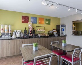 Complimentary breakfast area offering fresh coffee, cereals, pastries, and hot breakfast selections at Comfort Inn Sydney.
