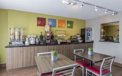 Complimentary breakfast area offering fresh coffee, cereals, pastries, and hot breakfast selections at Comfort Inn Sydney.