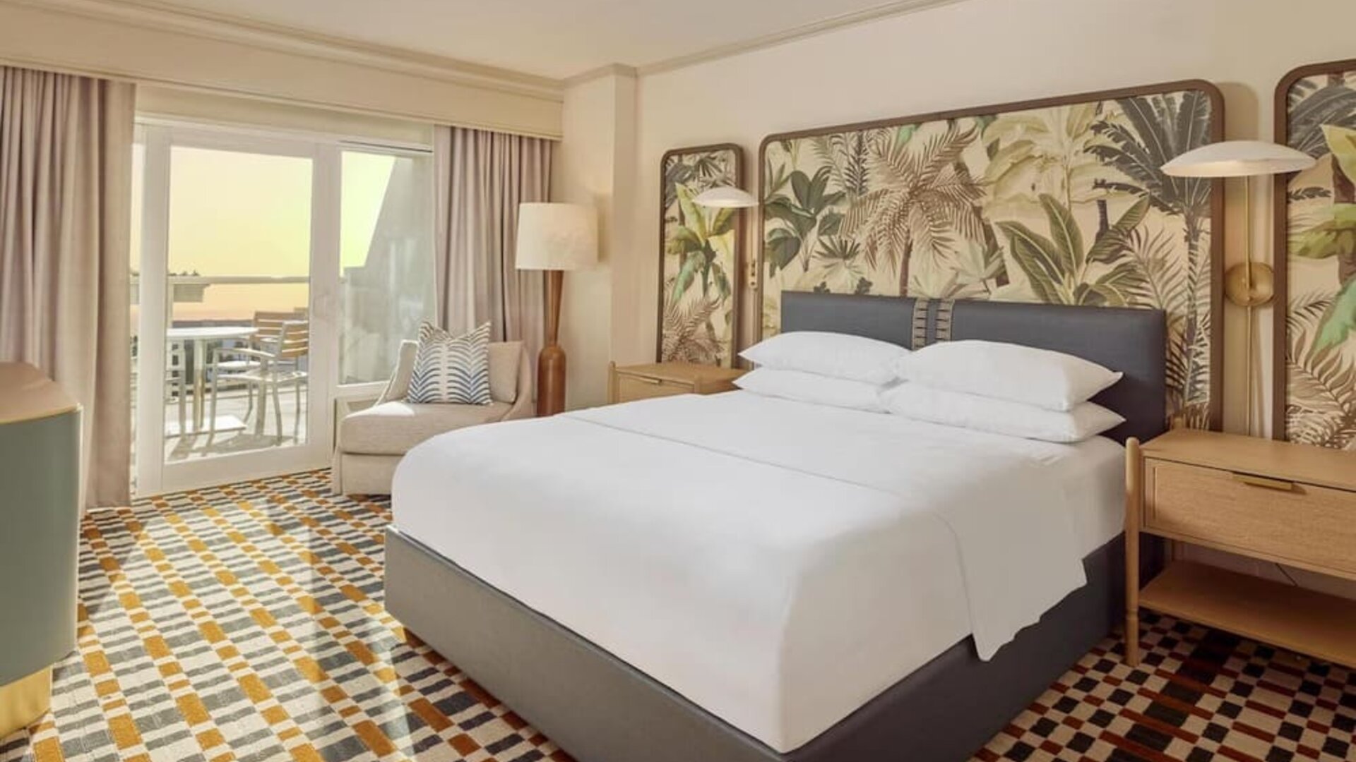 Stylish king guest room featuring plush bedding, private balcony, comfortable seating, and coastal-inspired décor at Hyatt Centric Delfina Santa Monica.