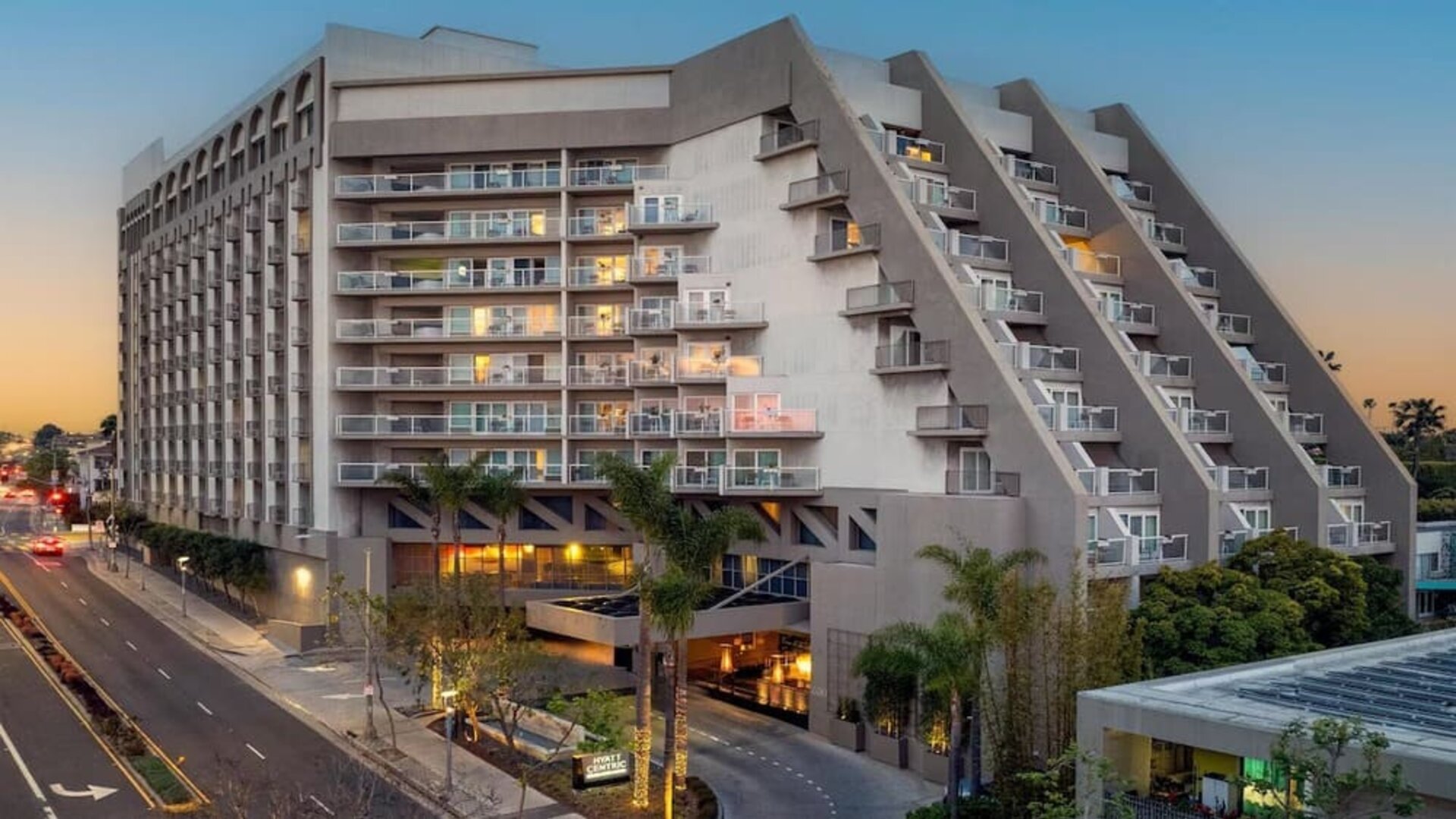 Evening exterior view of Hyatt Centric Delfina Santa Monica showcasing its modern design and convenient location near the beach and downtown attractions.