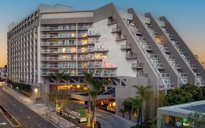 Evening exterior view of Hyatt Centric Delfina Santa Monica showcasing its modern design and convenient location near the beach and downtown attractions.