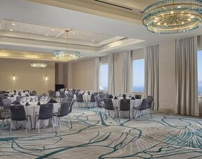 Elegant ballroom with flexible banquet seating, natural light, and modern décor for weddings, conferences, and special events at Hyatt Centric Delfina Santa Monica.