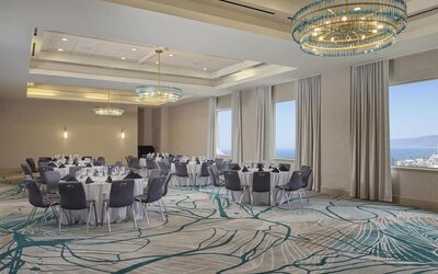 Elegant ballroom with flexible banquet seating, natural light, and modern décor for weddings, conferences, and special events at Hyatt Centric Delfina Santa Monica.