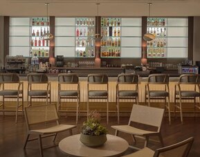 Modern hotel bar serving handcrafted cocktails, wine, beer, and light bites in a sophisticated lounge setting at Hyatt Centric Delfina Santa Monica.