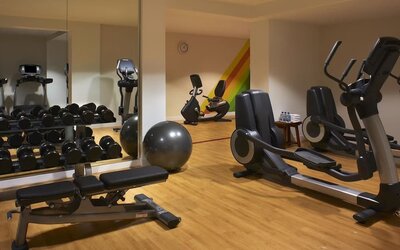 Fully equipped fitness center featuring cardio machines, free weights, strength-training equipment, and exercise space at Hyatt Centric Delfina Santa Monica.