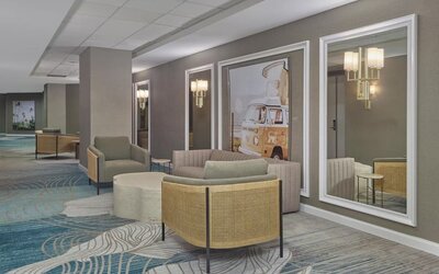 Comfortable lobby lounge with contemporary seating, modern artwork, and welcoming spaces to relax or socialize at Hyatt Centric Delfina Santa Monica.