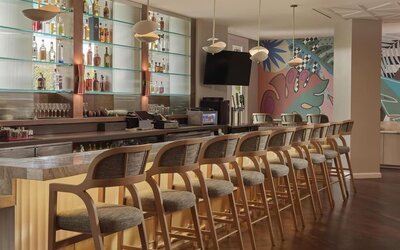 Contemporary hotel bar featuring handcrafted cocktails, premium spirits, and stylish seating in a vibrant social atmosphere at Hyatt Centric Delfina Santa Monica.