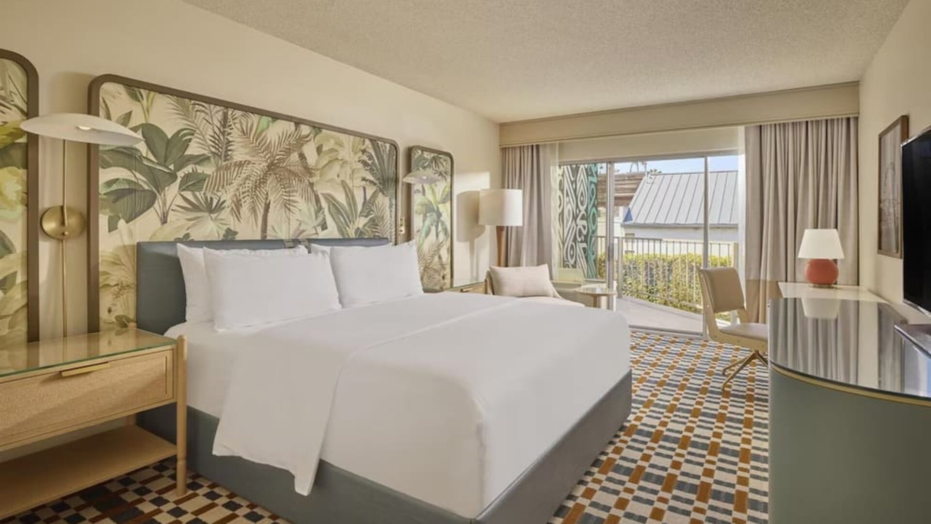 Bright king guest room featuring plush bedding, private balcony, ergonomic workspace, and contemporary coastal-inspired décor at Hyatt Centric Delfina Santa Monica.