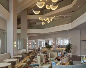 Contemporary hotel lobby featuring stylish lounge seating, modern lighting, and an inviting social atmosphere at Hyatt Centric Delfina Santa Monica.