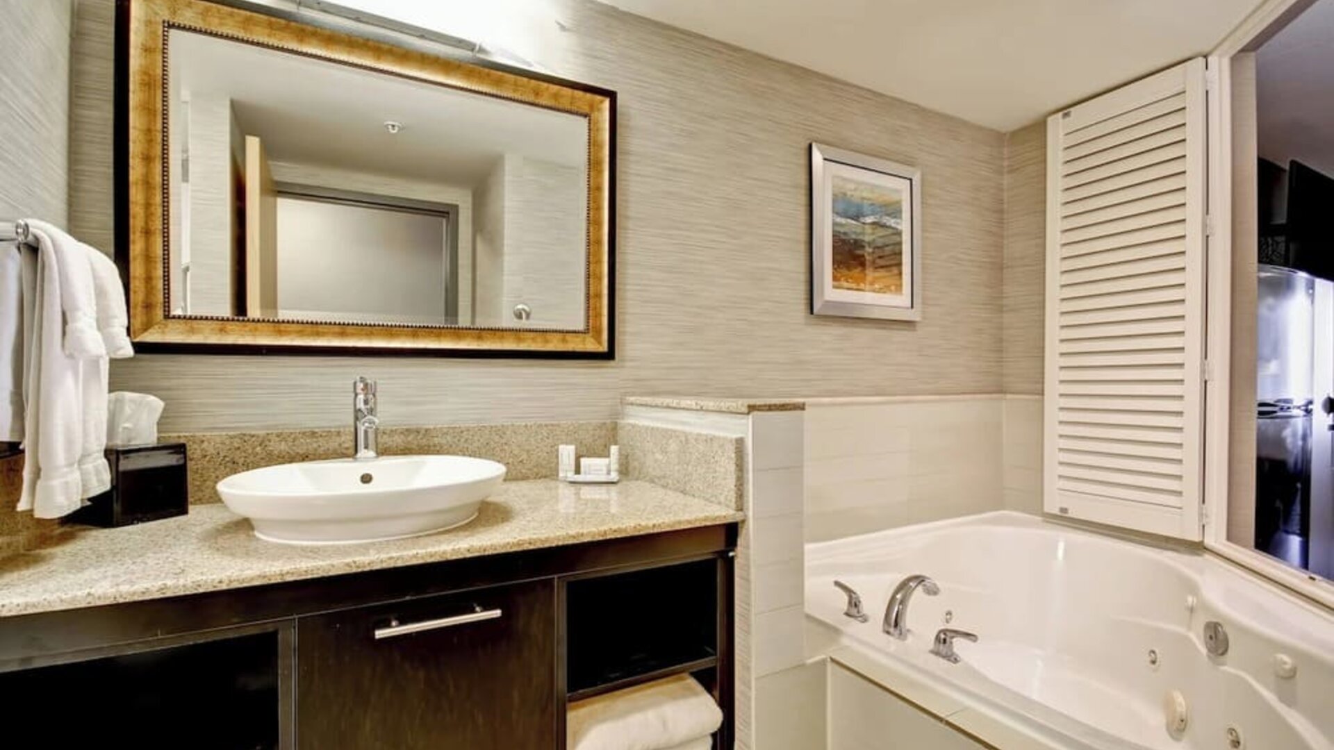 Contemporary bathroom featuring a whirlpool soaking tub, granite vanity, and modern finishes at Fairfield Inn & Suites Guelph.