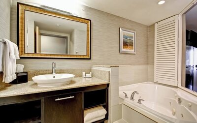 Contemporary bathroom featuring a whirlpool soaking tub, granite vanity, and modern finishes at Fairfield Inn & Suites Guelph.