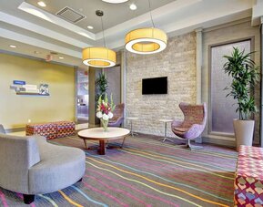 Stylish hotel lobby with comfortable seating, modern lighting, and a welcoming atmosphere at Fairfield Inn & Suites Guelph.