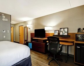 Contemporary king guest room with a spacious work desk, mini fridge, microwave, and flat-screen TV at Fairfield Inn & Suites Guelph.