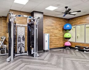 Fully equipped fitness centre featuring strength training equipment and functional workout space at Four Points by Sheraton St. Catharines Niagara Suites.