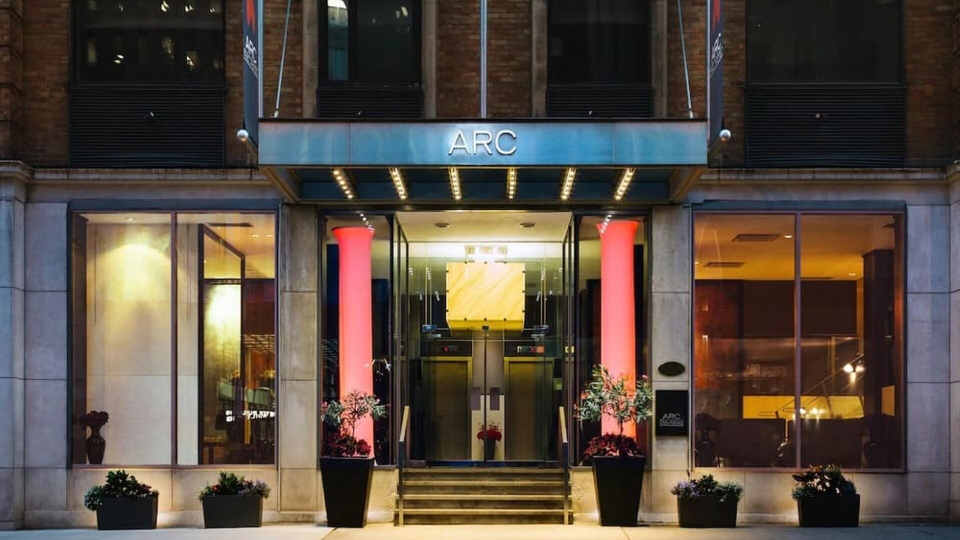 Elegant hotel entrance with contemporary architecture and a welcoming illuminated façade at ARC The Hotel Ottawa.
