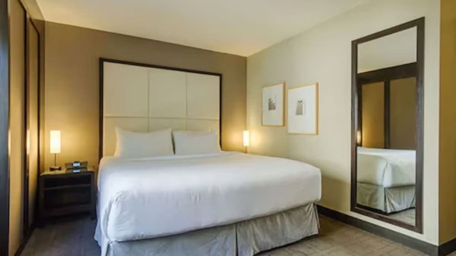 Contemporary guest room featuring a plush king bed, premium linens, and modern furnishings at ARC The Hotel Ottawa.