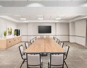 Flexible meeting room with modern furnishings, presentation screen, and space for business meetings or private events at Hyatt Place Scottsdale/Old Town.