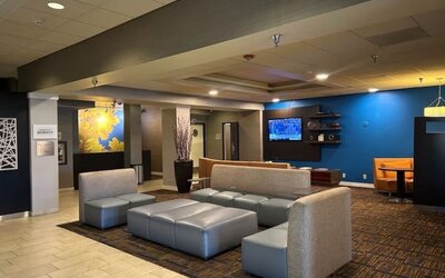 Contemporary hotel lobby with comfortable lounge seating, modern décor, and welcoming social spaces at Courtyard Riverside UCR/Moreno Valley Area.