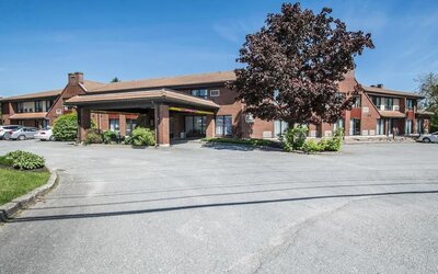 Exterior view of Comfort Inn Sherbrooke with convenient guest parking and a covered hotel entrance.